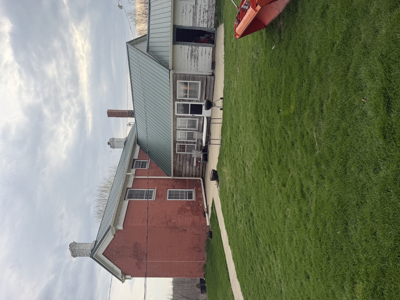 Historic home with standing-seam metal roofing over several connected roof slopes