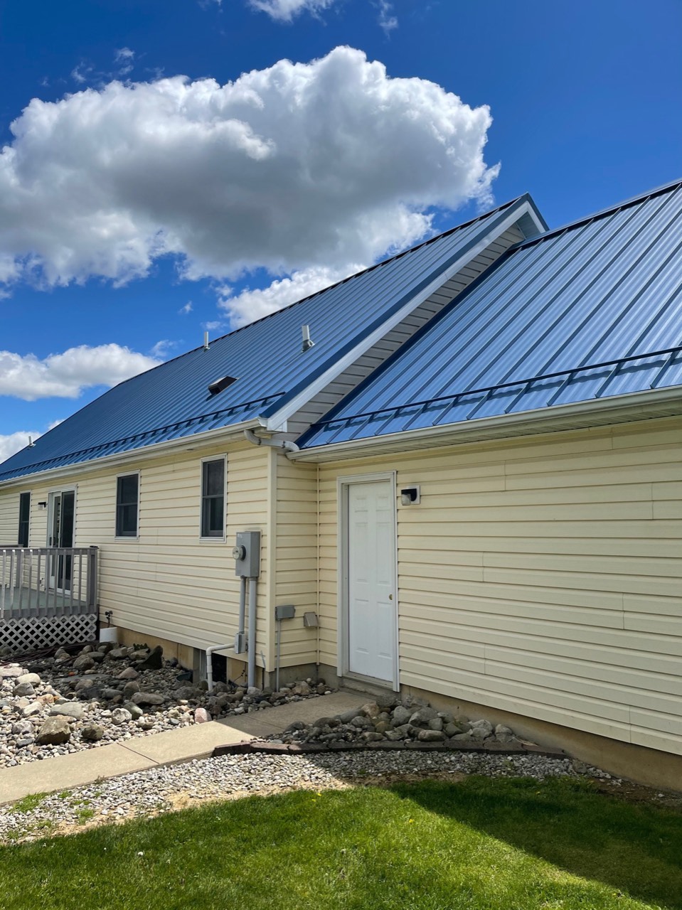 Metal roof edge with a visible gutter and downspout on a Fort Wayne-area home