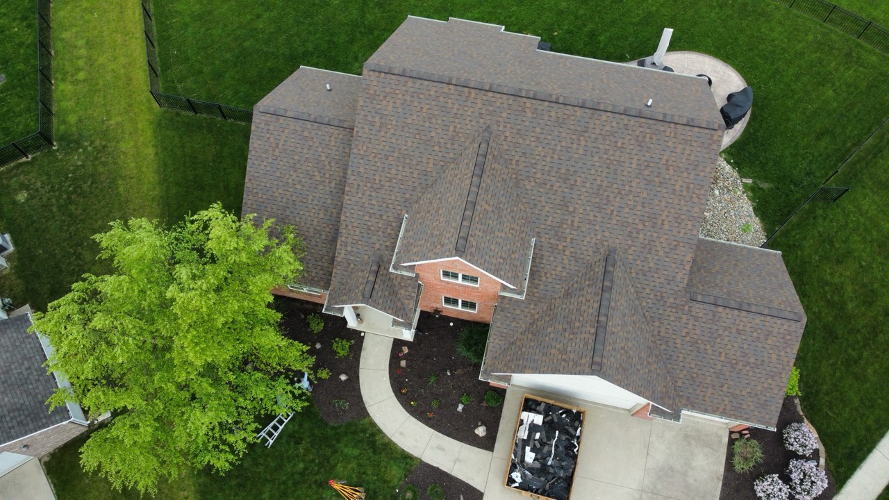 Aerial view of an asphalt-shingle roof with multiple intersecting valleys