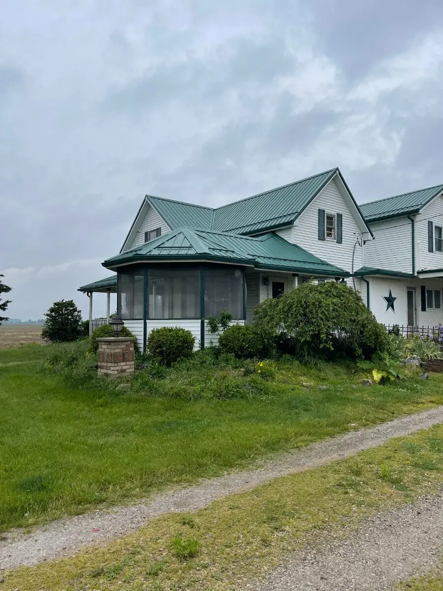 Green standing seam metal roof on farmhouse in Northeast Indiana