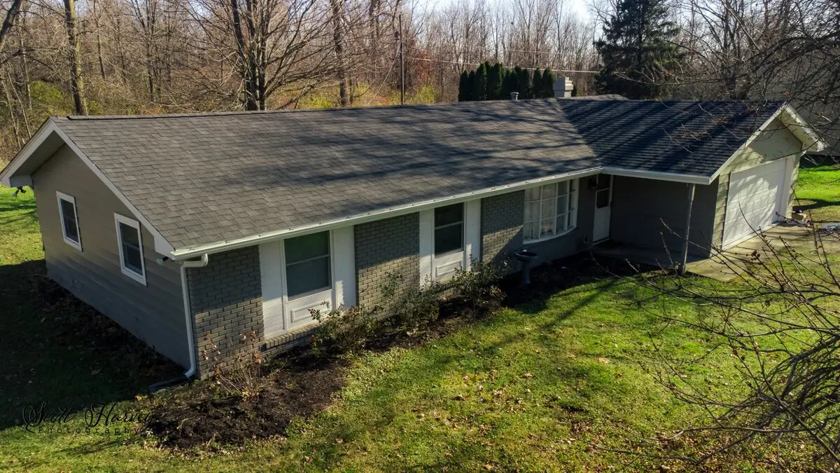 Drone view of completed shingle roof replacement on ranch home