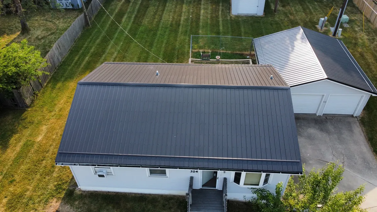 Aerial drone view of charcoal standing seam metal roof on residential home